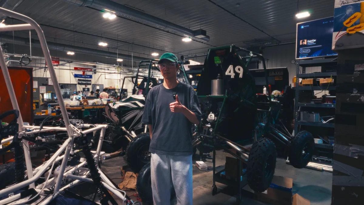 Ben with the Baja car in the team workshop