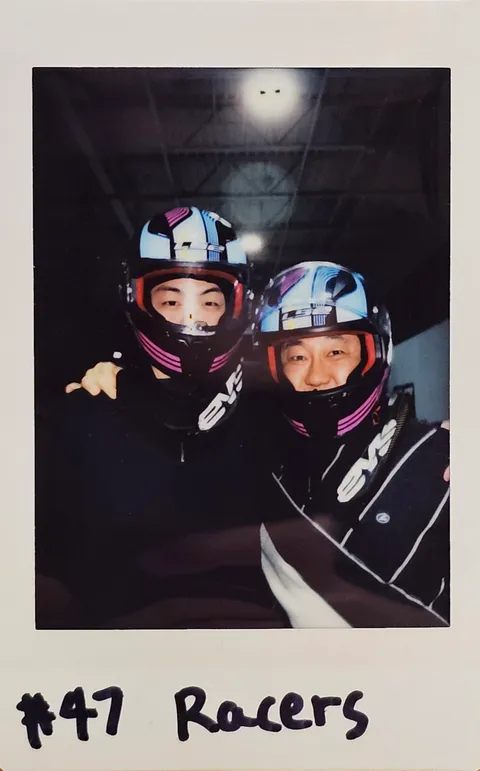 A Polaroid with family in racing helmets